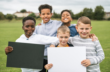 Group of young boys showing blank papers