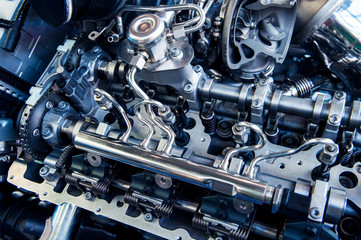 Fototapeta na wymiar The powerful engine of a car. Internal design of engine. Car engine part. Modern powerful car engine.