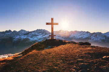 Cross on the top of the mount at sunset light, sunny alpine landscape, Sharek peak, Hohe Tauern...