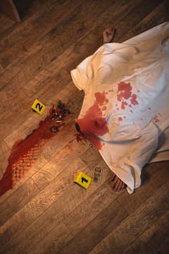 Top View Of Dead Body Covered With White Sheet At Crime Scene