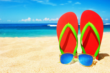 Fototapeta na wymiar Holidays Background. Beach sandals on the sandy coast