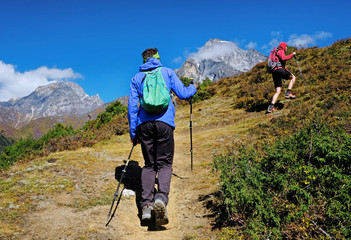 Fototapeta na wymiar Hiker with backpacks enjoy the track to Everest Base Camp. Success, freedom and happiness, achievement in mountains. Active sport concept.