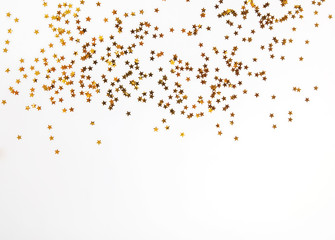 Golden glitter decor on the white background with copy space