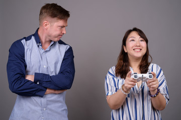 Portrait of multi ethnic diverse couple reading diary book