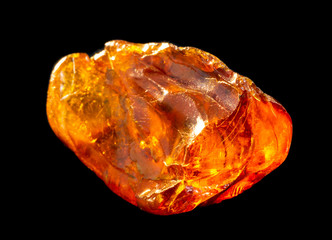 Natural piece of amber on a black background