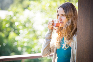 Young woman drinking herbal tea outdoors
