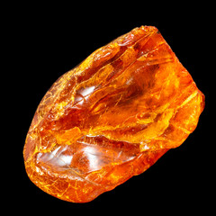 Natural piece of amber on a black background