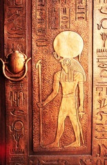 Egyptian hieroglyphs on the door. Hieroglyphic carvings on the exterior walls of an ancient...