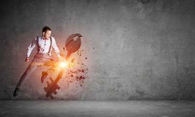 Breaking through access concept with furious man in room crashing concrete key