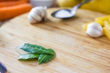 Bay leaves over wooden board