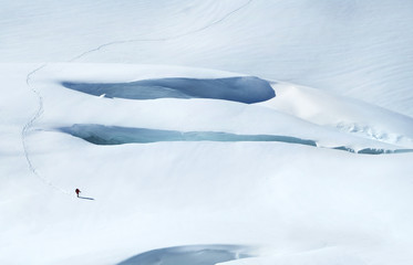 Hiker with backpacks on the glacier. Active sport concept.