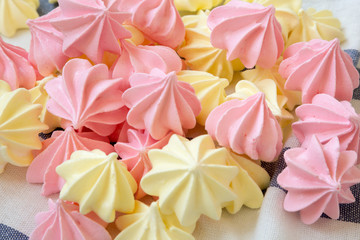 Mini meringues on striped napkin, side view. Close-up.
