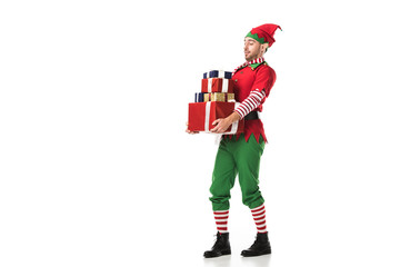 man in christmas elf costume carrying pile of presents isolated on white