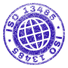 ISO 13485 stamp print with distress style. Blue vector rubber seal print of ISO 13485 title with corroded texture. Seal has words placed by circle and globe symbol.