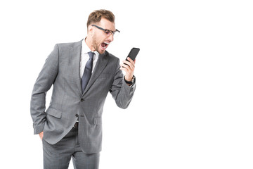 angry adult businessman shouting at smartphone isolated on white