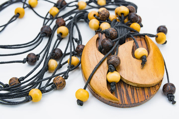 Ethnic Indonesian necklaces. Women's jewelry made of tropical wood and bundles on white background 