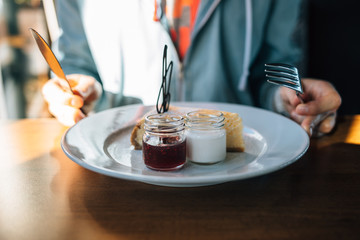 Young woman sitting indoors at table in cafe