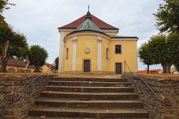 Obraz premium Landscape view of medieval Church of Our Lady of Carmel in Kostelni Vydri village in cloudy summer day. South Bohemian Region, Czech Republic
