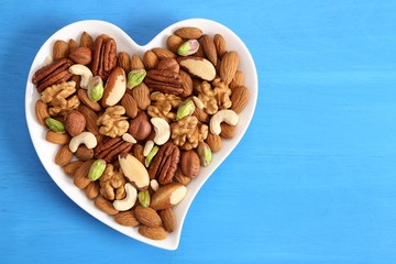 Nuts on a plate in the shape of a heart.