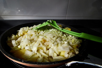 Cooking a Spanish omelette with potatoes and onions
