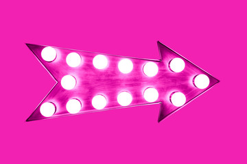 Pink arrow shaped vintage colorful illuminated metallic display direction sign with glowing light bulbs isolated on an intense same color bright vivid pink background. - 233174804