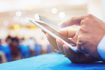 hand using smart phone in conference room
