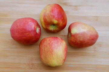 Group of red apples on wooden surface