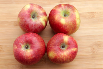 Group of red apples on wooden surface