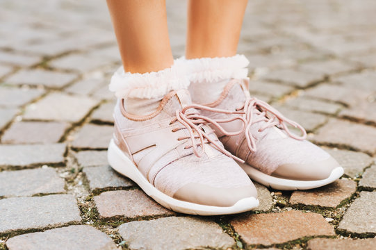 Woman Wearing New Comfy Trainers And Soft Pink Ruffle Socks, Close Up Image