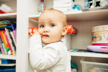 Portrait of adorable baby biting finger