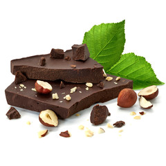 Broken chocolate blocks, cracked pieces and hazelnuts or filberts isolated on white background