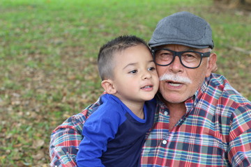 Fototapeta na wymiar Protective grandfather with baby grandson 