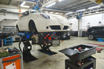  Car technician repairing car in workshop service station