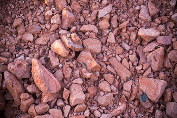Rouge rock for road reclamation work.Laterite Pattern. lateritic soil textured background.Background of broken pottery.Cracked substrate of Thailand