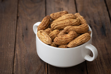 dry peanuts on white bowl