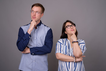 Portrait of confident multi ethnic diverse couple thinking