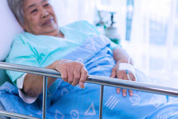 Senior patient sitting on bed at hospital. Sad disabled at the hospital 