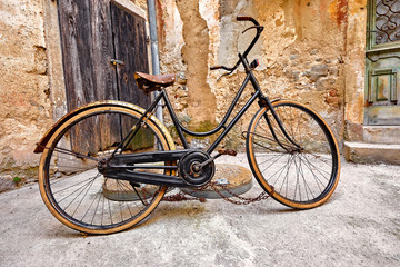 Fototapeta na wymiar Old retro bicycle on vintage street in Croatia background aged