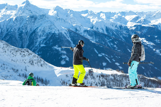 Active family skiing with a child on a mountain slope