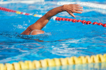 Active senior swimming. Senior man swimming in an outdoor swimming pool.