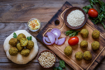 falafel with pita and vegetable salad and hummus with pine nuts