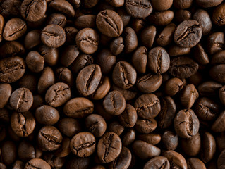 Roasted coffee beans as backgroundon the table