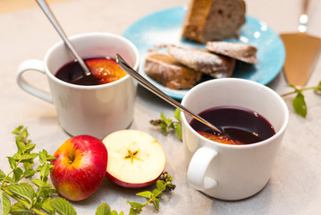 Hot mulled red wine with traditional Czech cake called babovka, on the concrete table