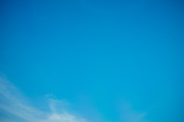 Fototapeta na wymiar Clear blue sky with small white clouds.