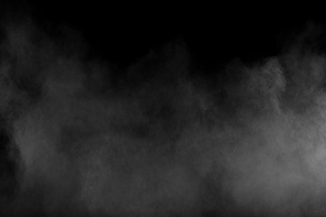 Bizarre forms of white powder explosion cloud against black background.White dust particles splash.
