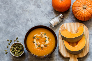 pumpkin soup with pumpkin seeds and cream on a light background