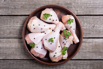 Raw chicken legs with spices and parsley. Food background