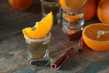 Tequila, orange slices and cinnamon sticks.