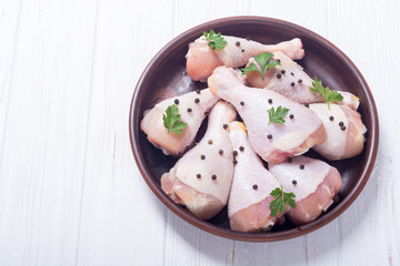 Raw chicken legs with spices and parsley. Food background