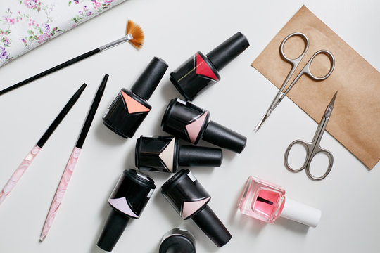 Collection of a manicurist. Nail polish of different shades, scissors, and brushes